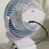 Go Fan Portable Cooling Fan Mist USB Rechargeable, in white and blue, with a clip-on base and a central misting nozzle.