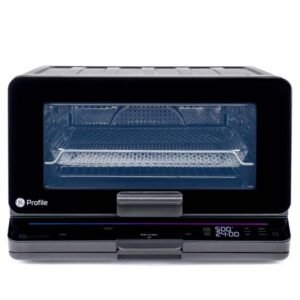 GE Profile smart oven with a touch control panel, showing the interior with a wire rack and a fry basket. The digital display reads "5:00" and "24:00."